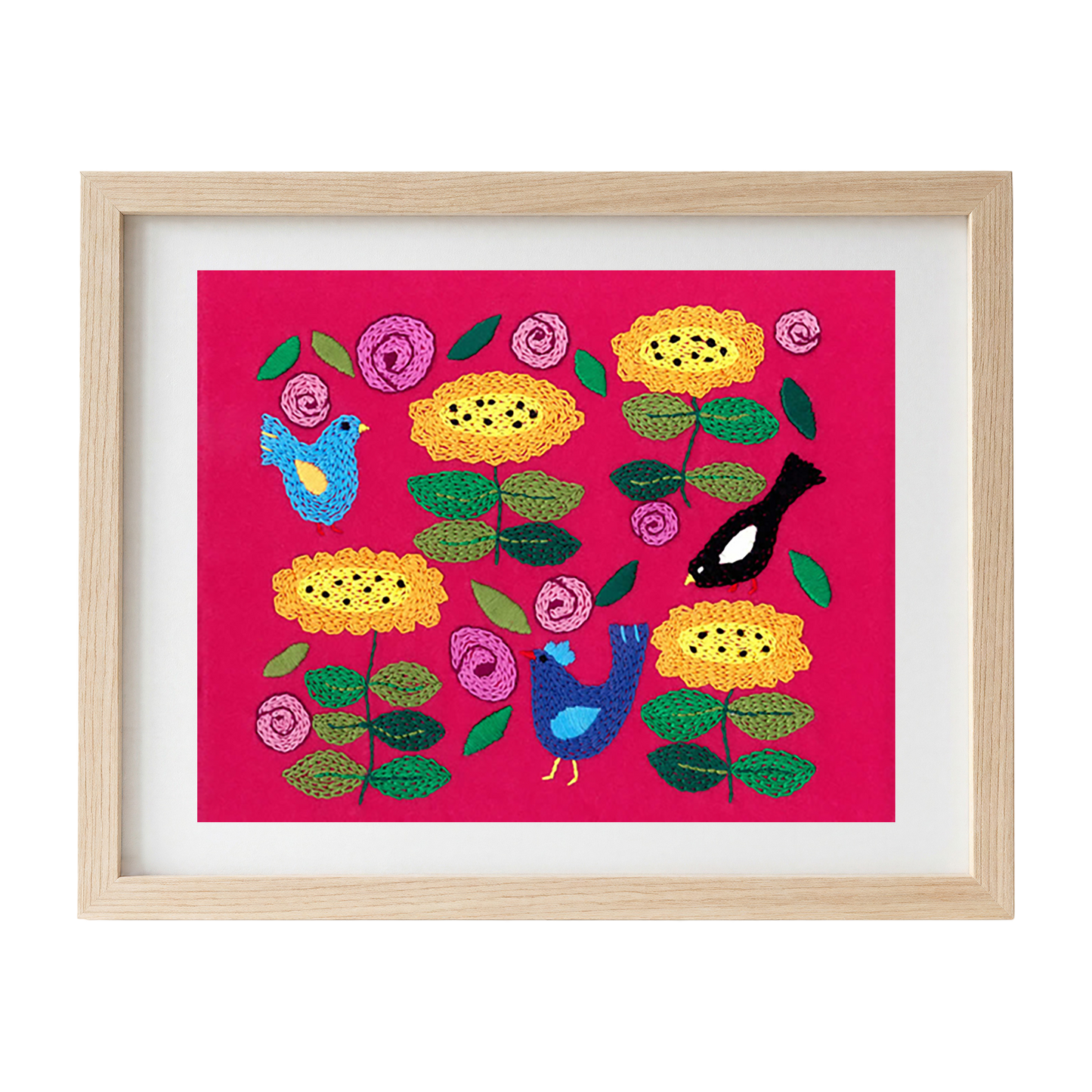 Framed embroidered artwork with colourful flowers and birds on a pink felt background