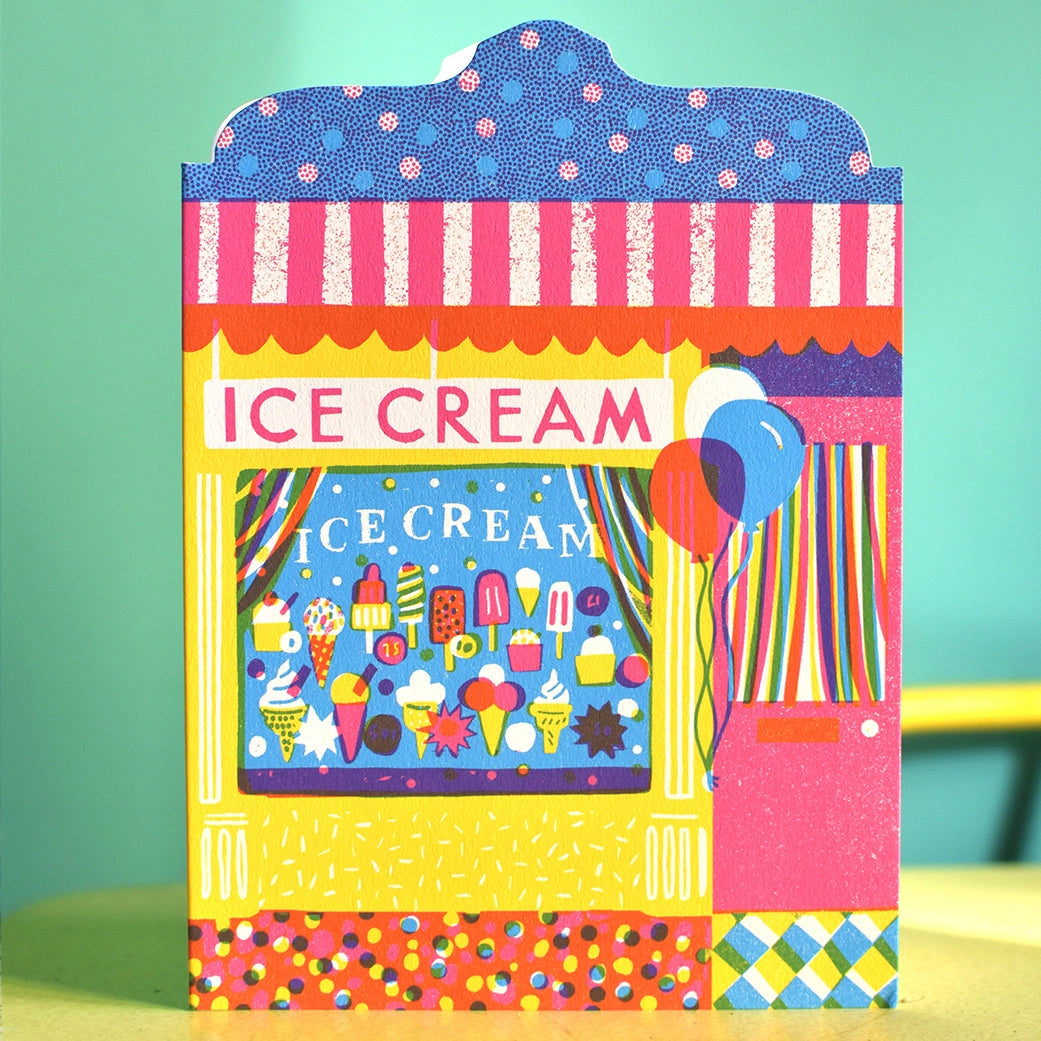Illustrated note card featuring colourful ice cream store front on a green background