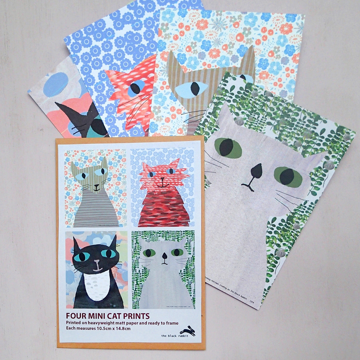 Four mini cat prints kraft packaging with illustrations of contents and four cat prints in the background