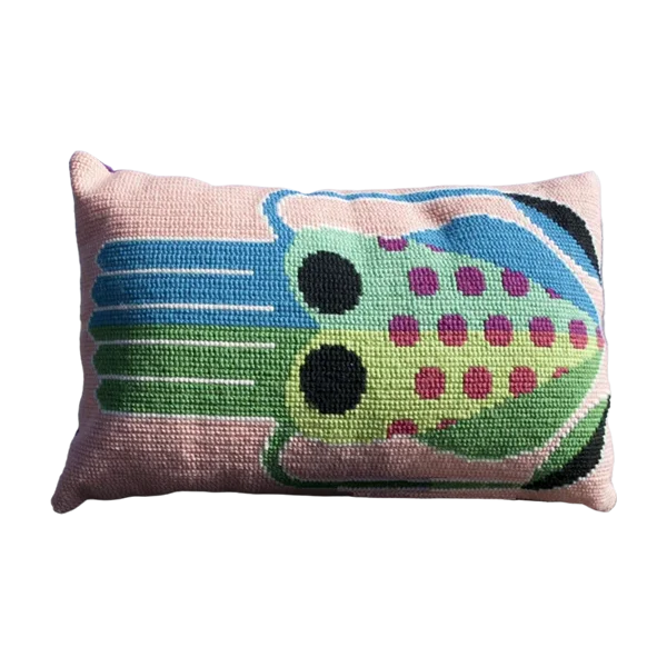 Cross stitch cushion with a vibrant squid motif in pink, blue and green tones