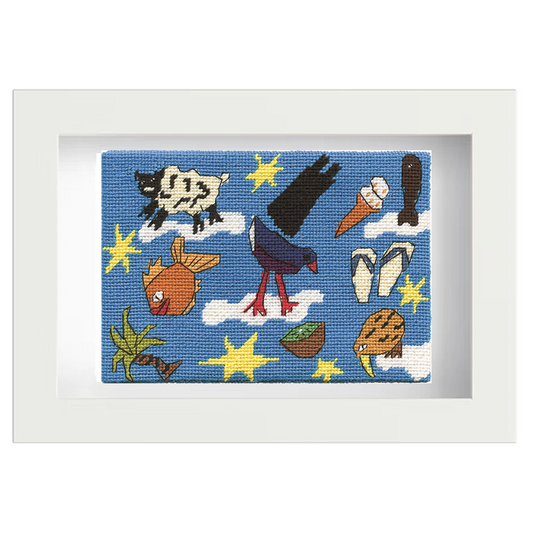 Framed needlepoint with colourful New Zealand icons on a blue background