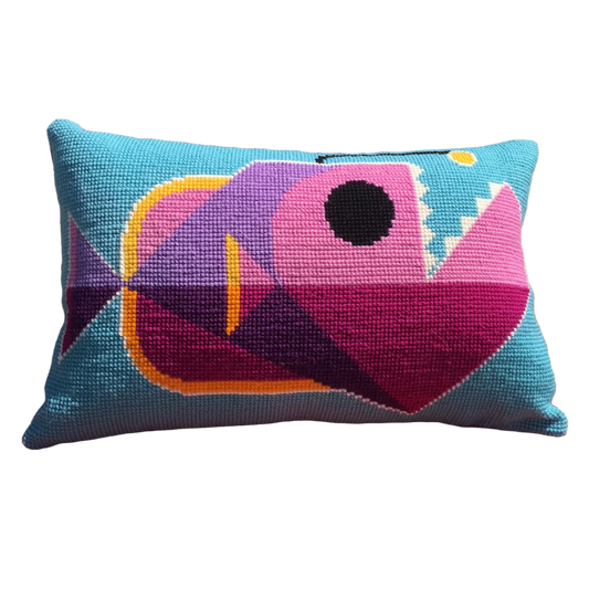 Cross stitch cushion with a quirky anglerfish design in blue, pink and purple