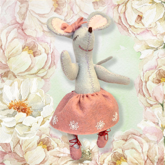 Felt mouse ballet dancer wearing a pink skirt and ballet slippers, set against a floral background