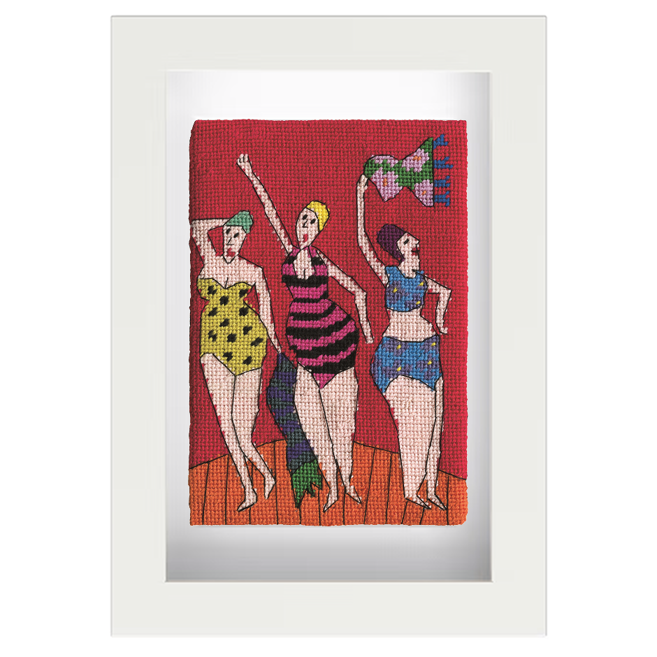 Needlepoint postcard of women in brightly coloured bathing costumes and caps, waving towels on a boardwalk, on a red background, framed in white