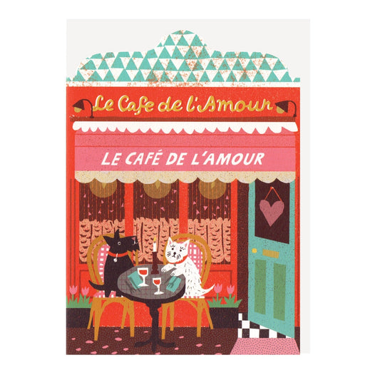 Illustrated card featuring Café de l'Amour, with café curtains, blue-green open door and heart sign, and two dogs sitting at a table outside, set on a white background