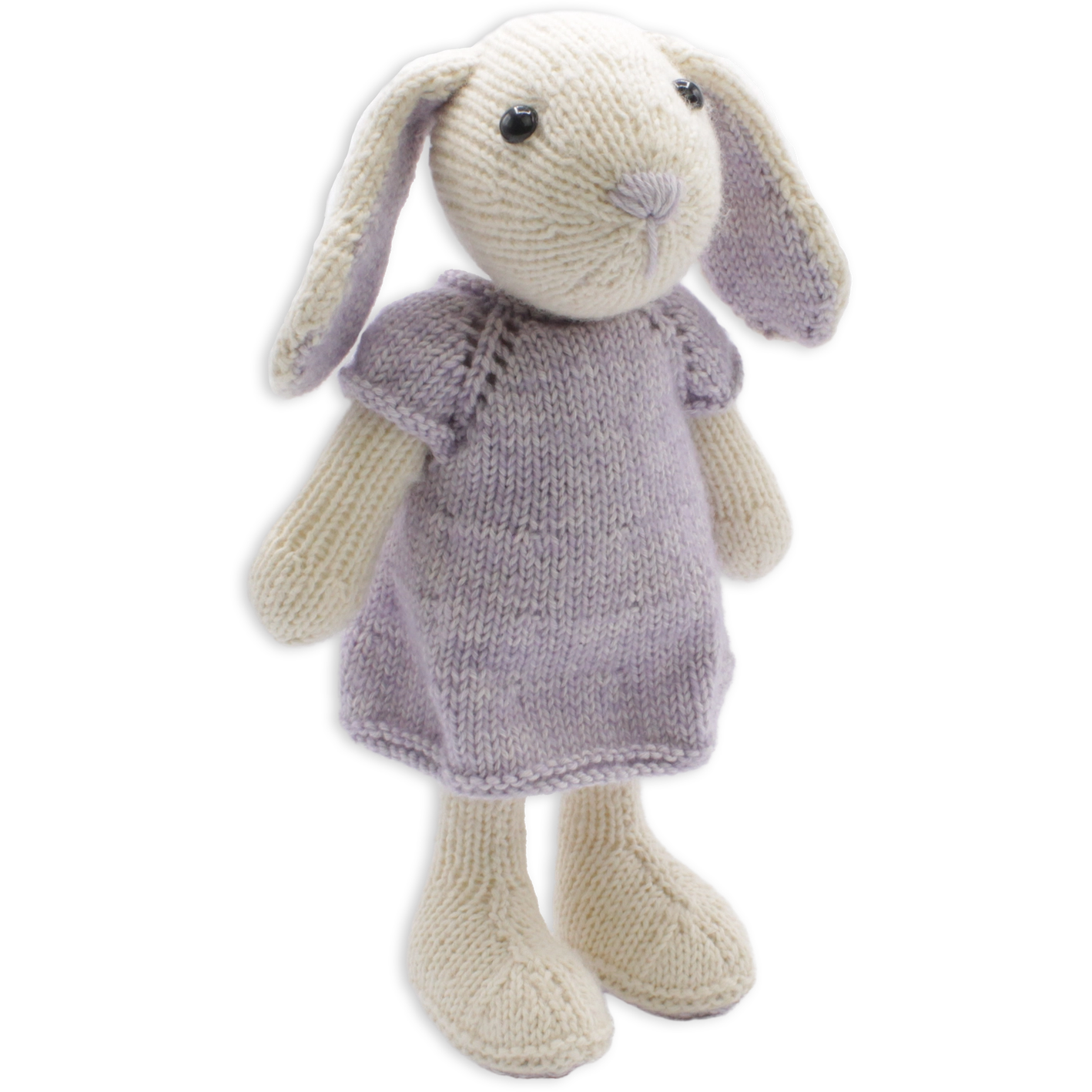 Cream-coloured knitted bunny soft toy wearing light purple dress on white background