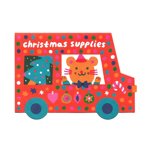 Illustrated note card featuring an animal driving a festive van with a Christmas tree