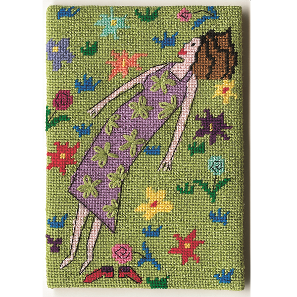 Unframed needlepoint postcard of a woman lying in a colourful field watching clouds, on a green background