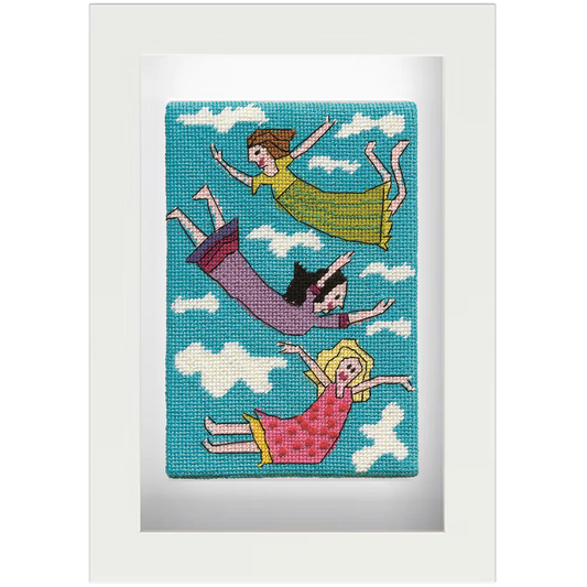 Needlepoint postcard of three women in brightly coloured frocks floating in the clouds on a sky blue background, framed in white