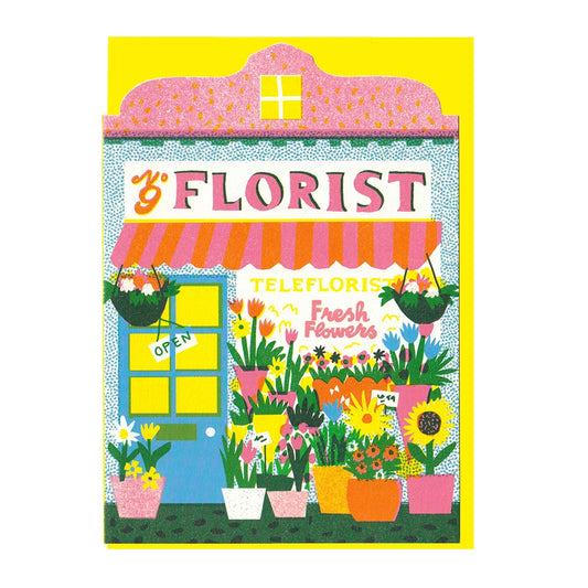 Illustrated note card featuring a colourful florist shop front with pots and vases full of flowers, with a yellow envelope
