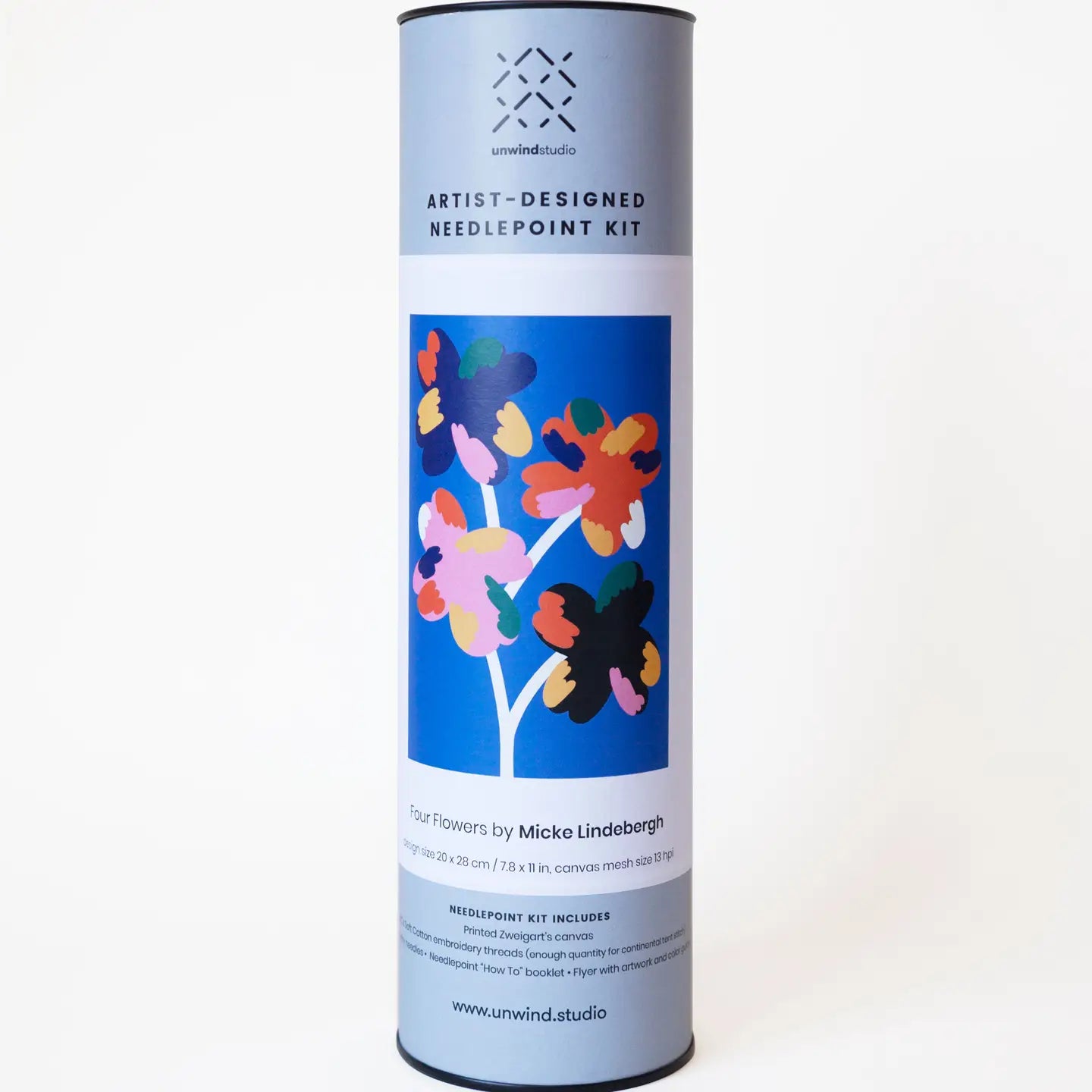 Tube packaging for a needlepoint kit with an brightly-coloured abstract floral  label