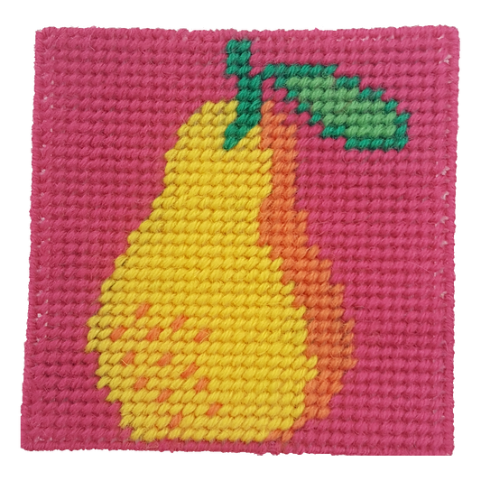 Close-up of a pear needlepoint design in pink, yellow, orange, and green