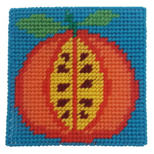 Close-up of a persimmon needlepoint design in orange, green, and blue