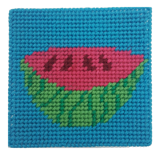 Close-up of a watermelon needlepoint design in pink, green, and blue
