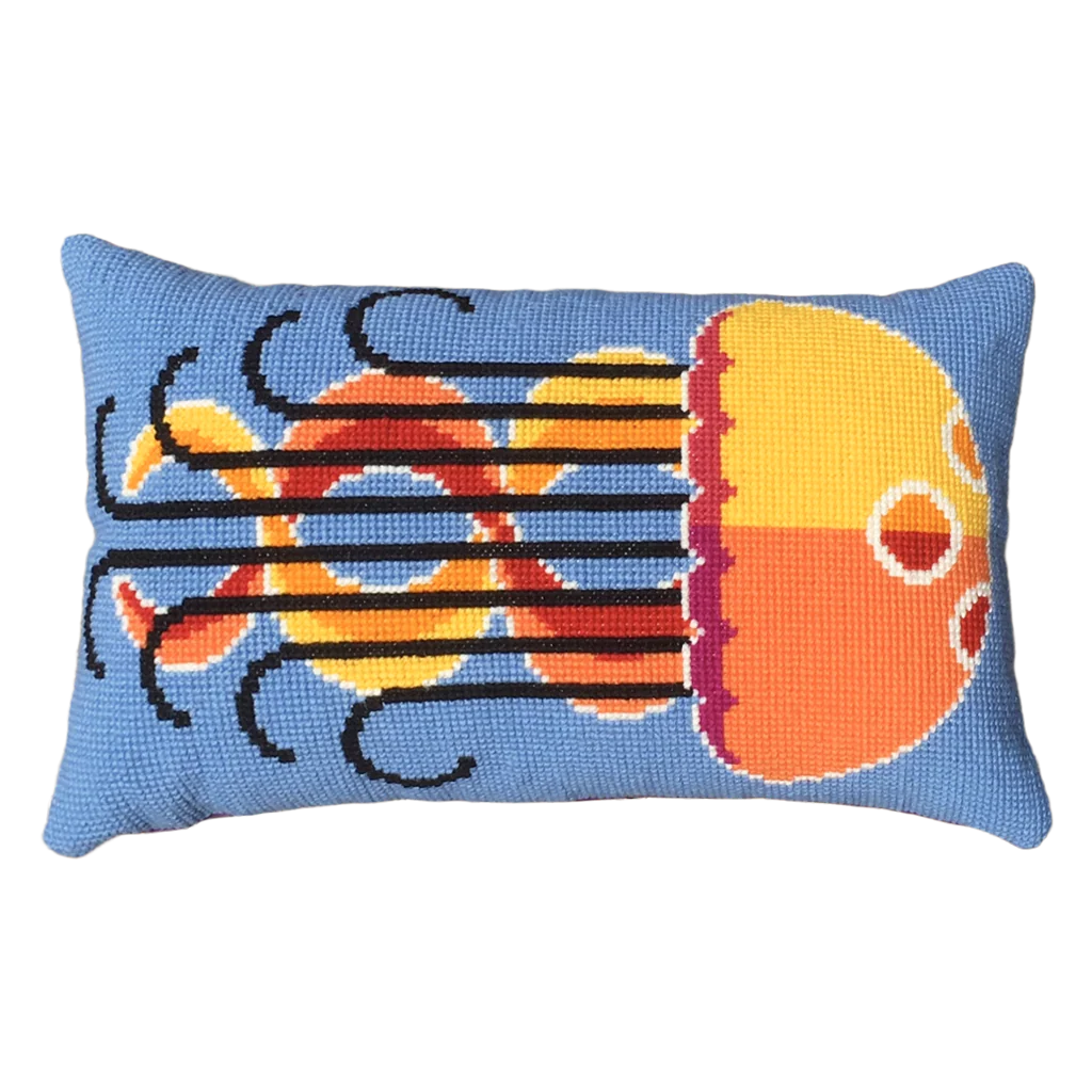 Cross stitch cushion featuring a colourful jellyfish design on a geometric background