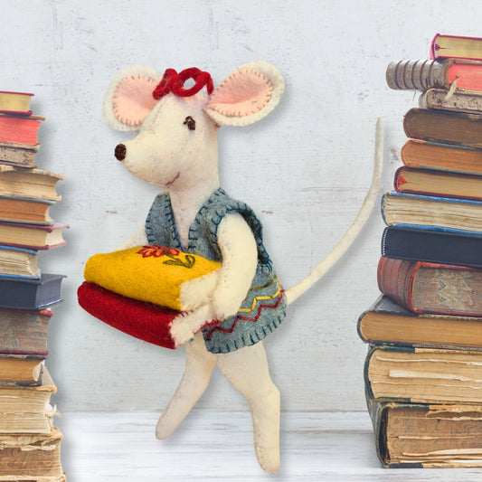 Felt mouse librarian wearing a blue jacket and carrying a stack of books