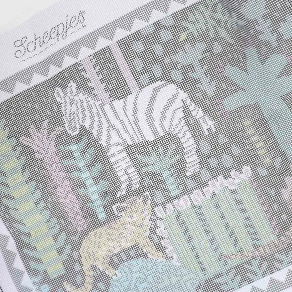 Close-up of a cross-stitched design featuring a zebra on a canvas fabric with 'Scheepjes' branding