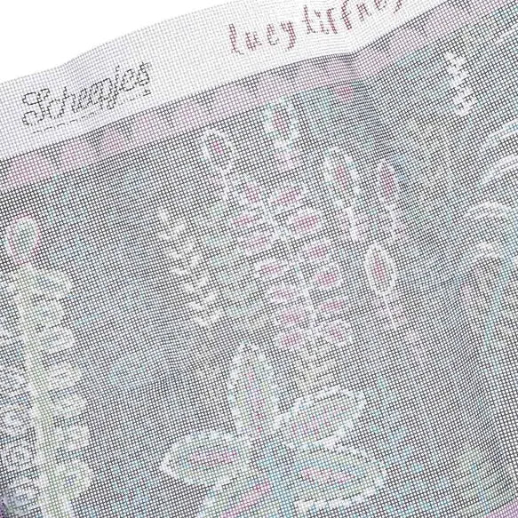 Close-up of a needlepoint canvas fabric with Lucy Tiffney branding