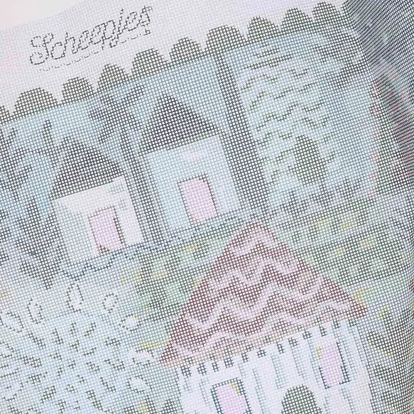 Close-up of a needlepoint canvas pattern with Scheepjes and Lucy Tiffney branding