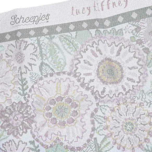 Close-up of a needlepoint canvas pattern with Scheepjes and Lucy Tiffney branding