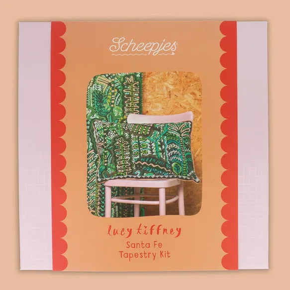 Santa Fe needlepoint kit packaging by Lucy Tiffney and Scheepjes with a green botanical cushion displayed on a chair