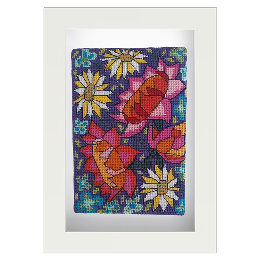 Colourful needlepoint postcard with large flowers in red, pink, orange, and yellow on a purple and blue background, framed in white