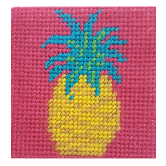 Close-up of a pineapple needlepoint design in yellow, green and pink