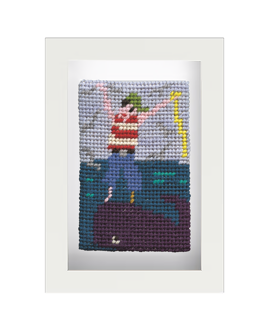 A completed, framed needlepoint kit depicting a pirate on a blue background, completed with colourful details