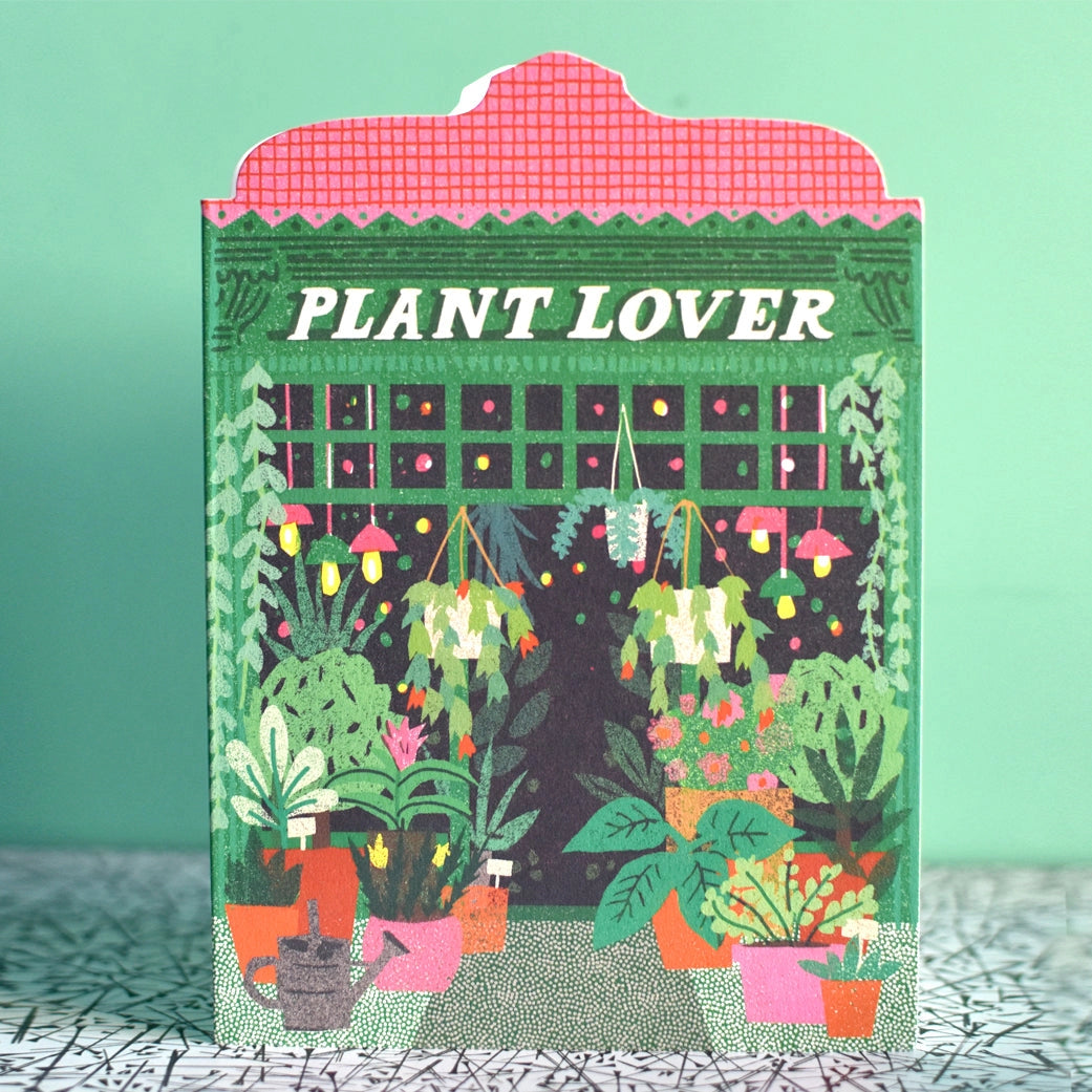 Illustrated note card depicting Plant Lover store front, with many colourful pot plants on green and tiled background