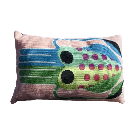 Cross stitch cushion with a vibrant squid motif in pink, blue and green tones