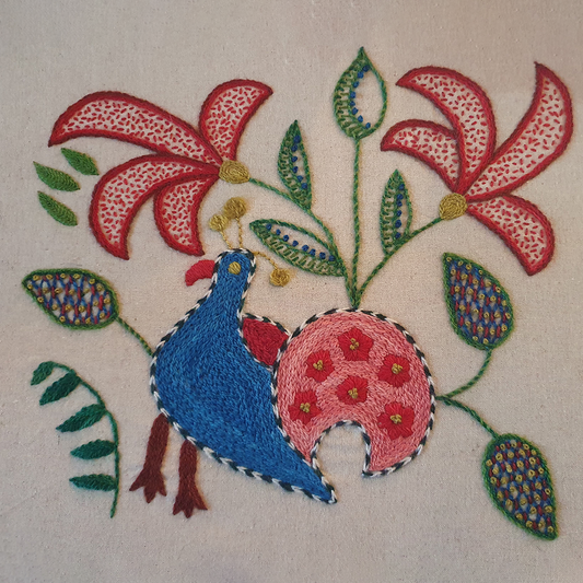 Embroidered design of a bird with flowers and leaves on a natural fabric background