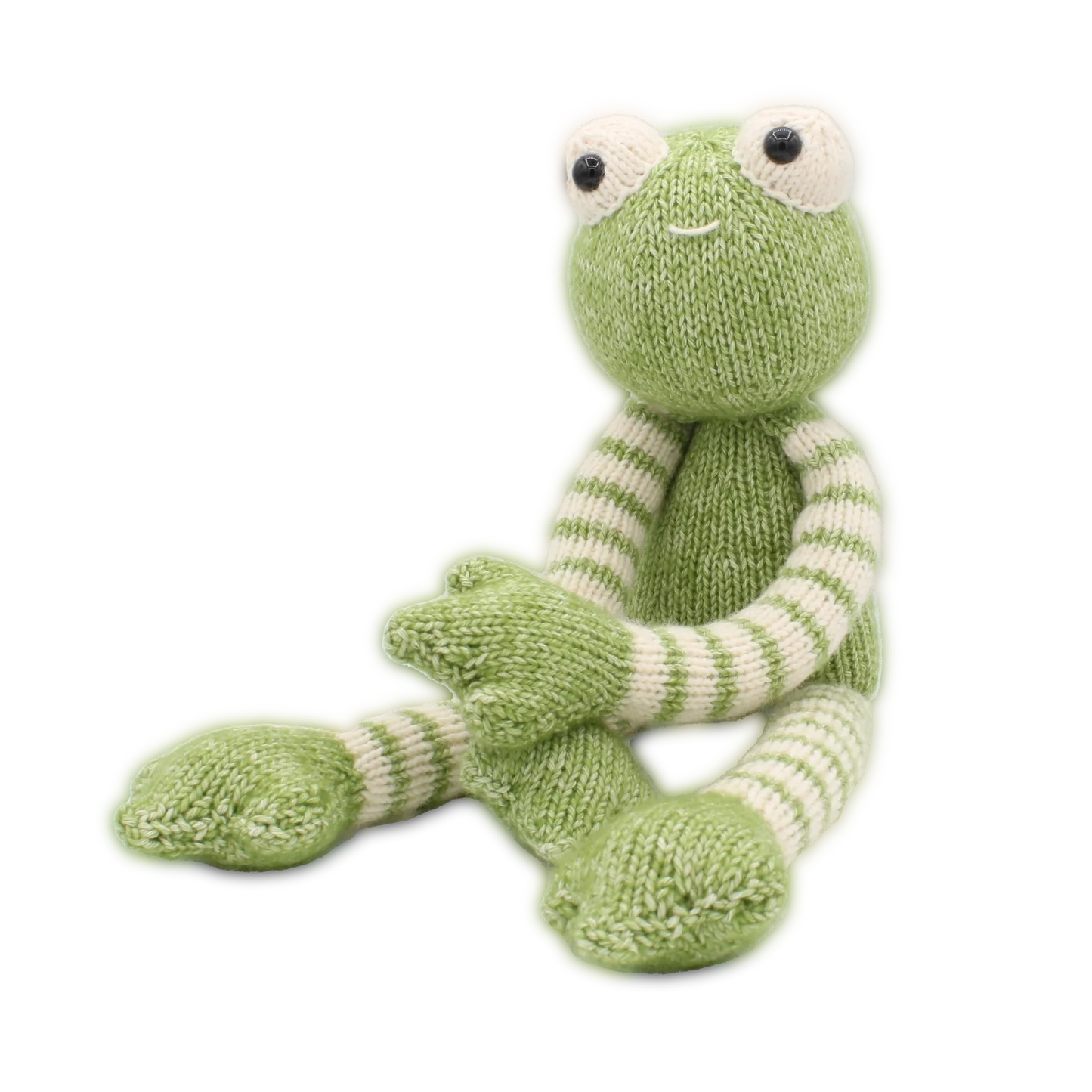 Knitted green and white frog soft toy on a white background