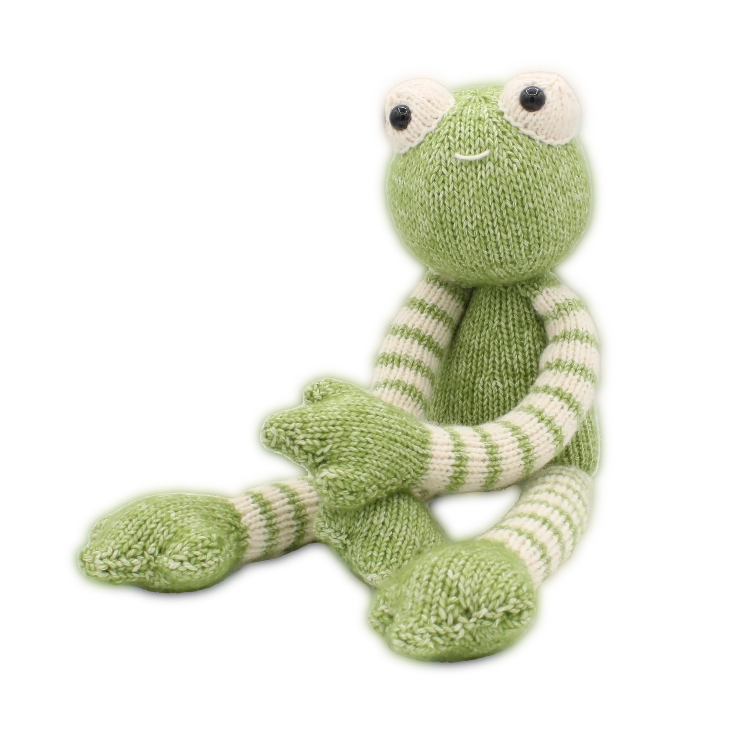 Knitted green and white frog soft toy on a white background
