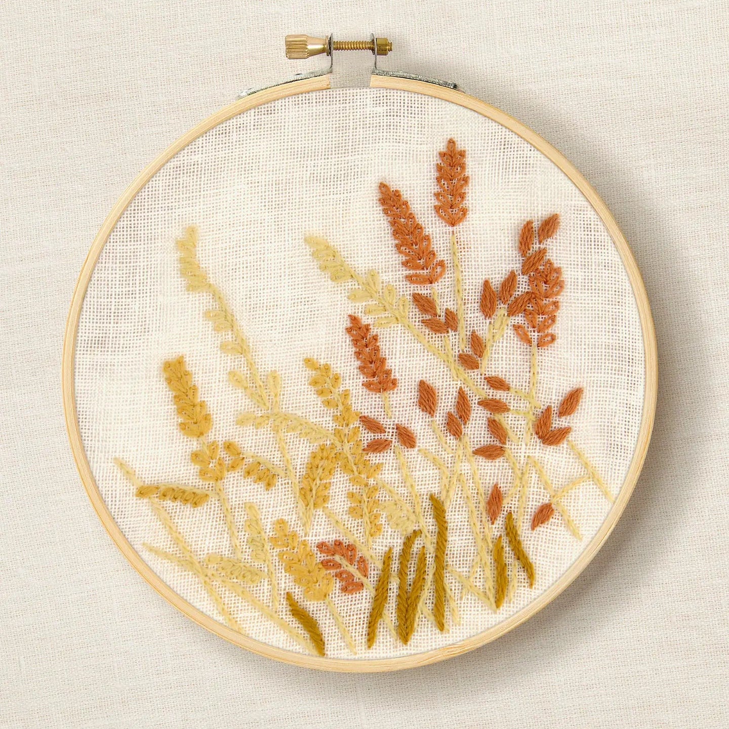 Embroidery hoop with botanical pattern on a cream background